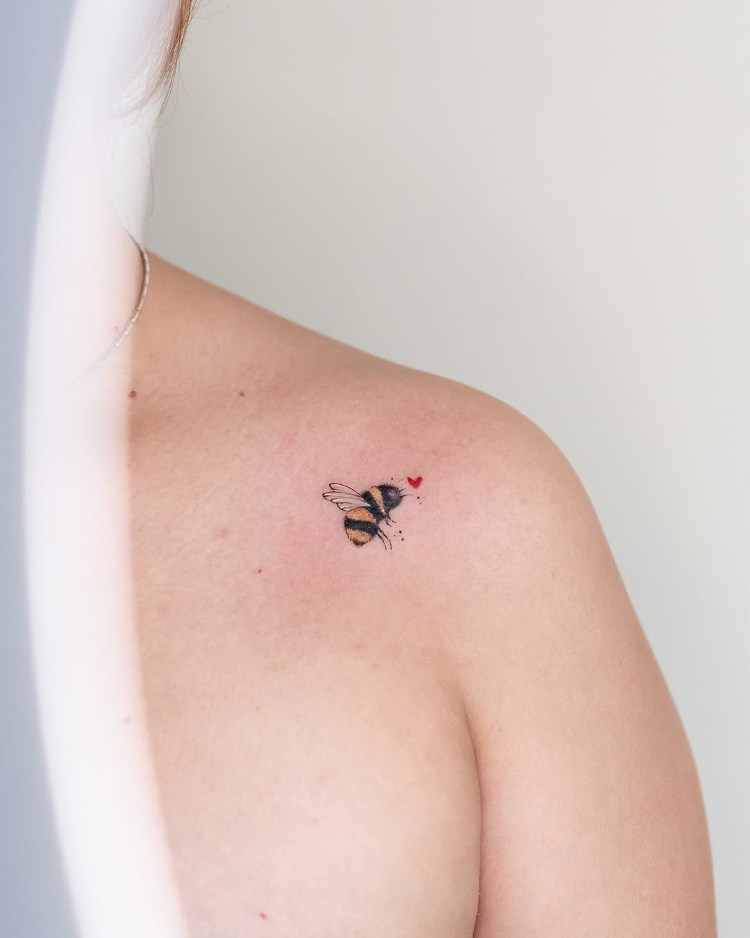 Charming bumblebee tattoo with heart accents