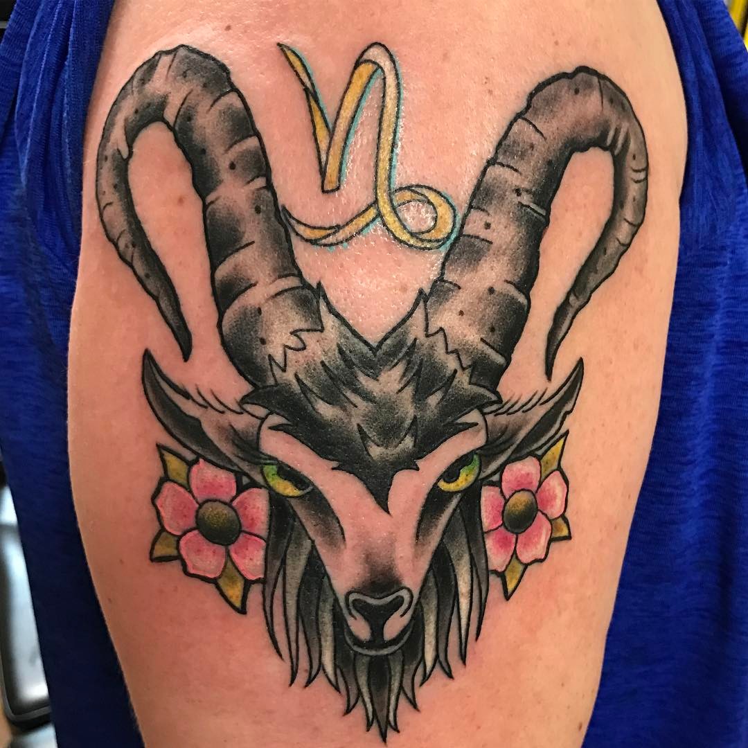 Stylish Capricorn goat tattoo with floral accents