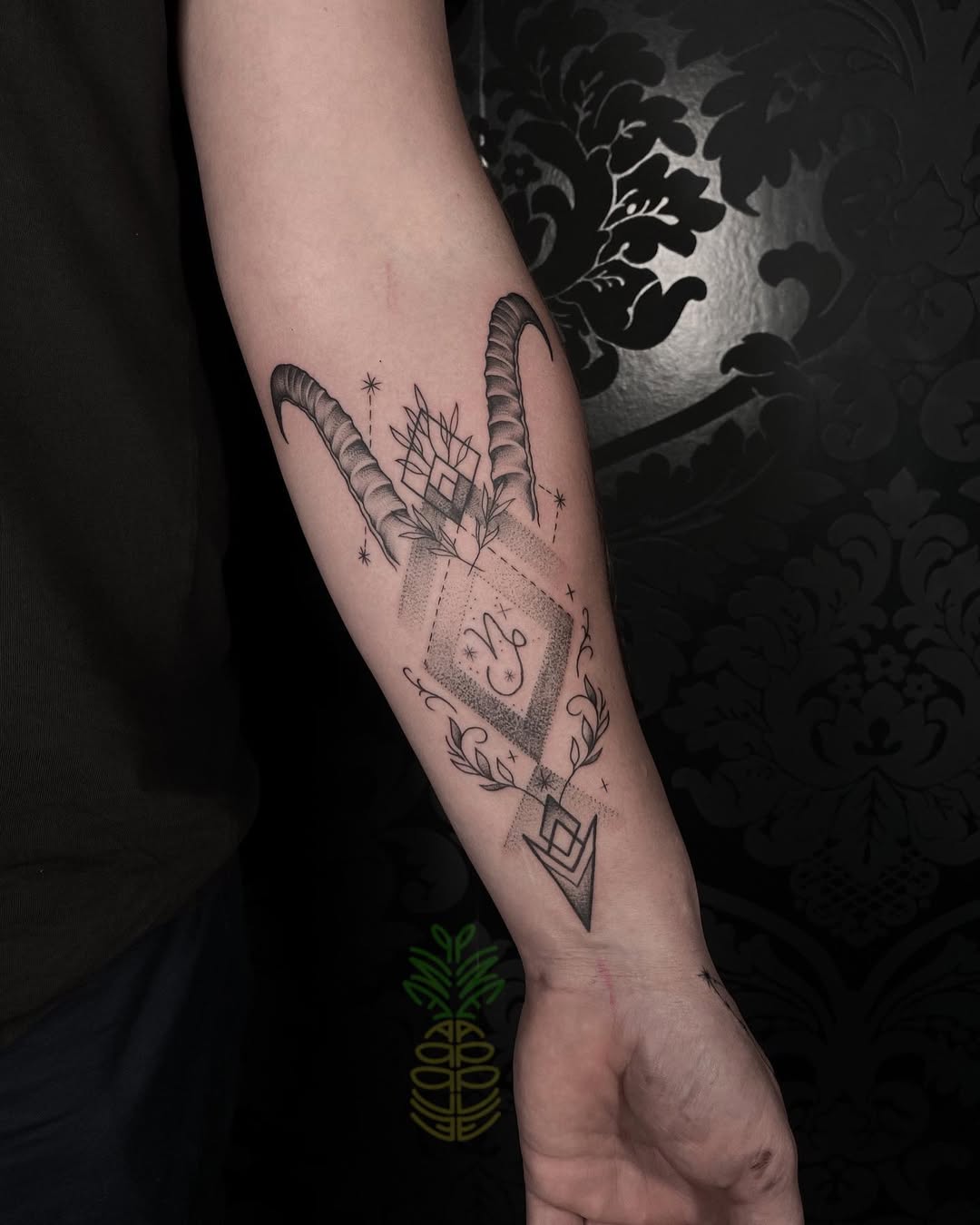 Elegant Capricorn tattoo with geometric elements