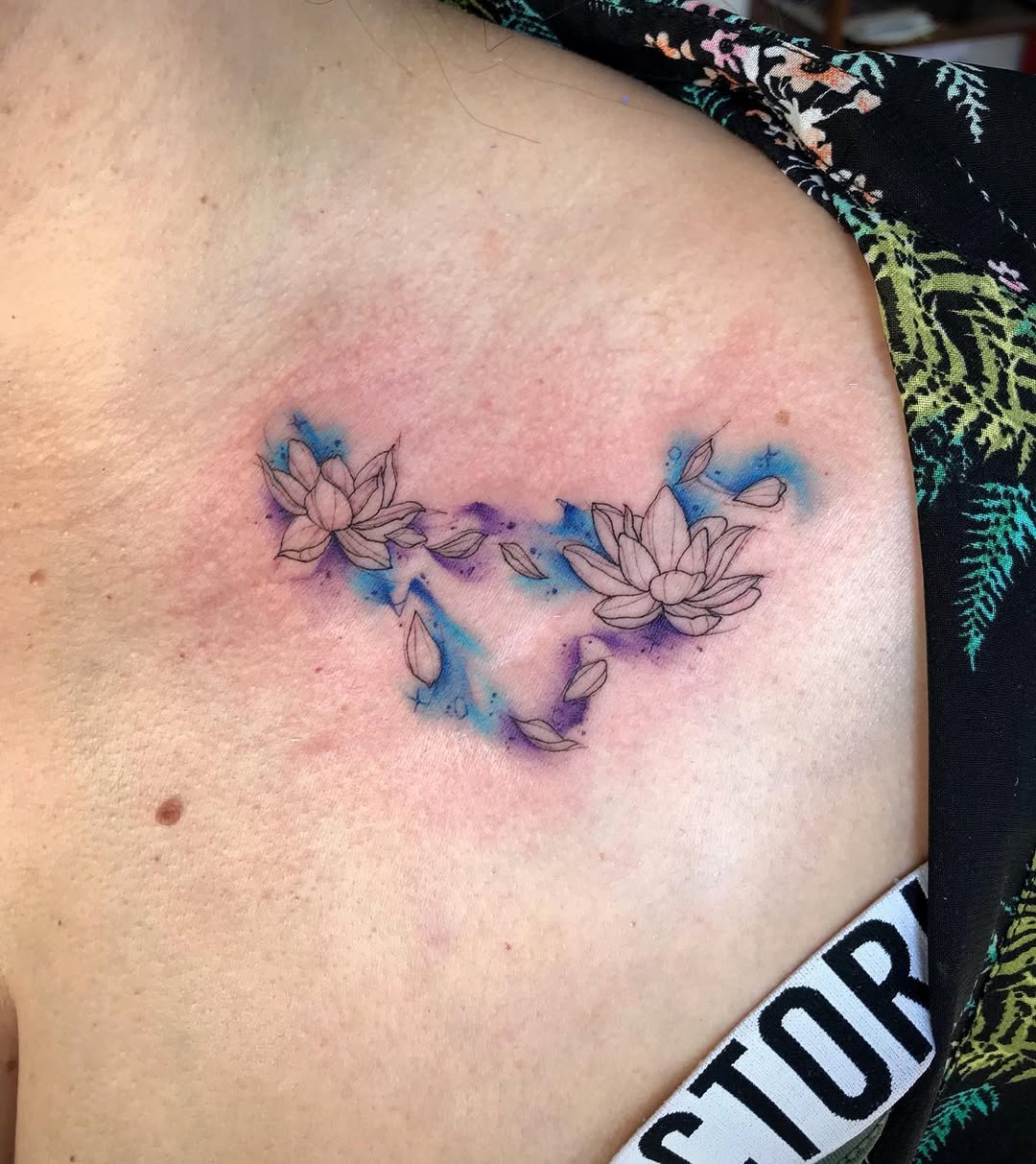Elegant Capricorn Tattoo Featuring Lotus Flowers