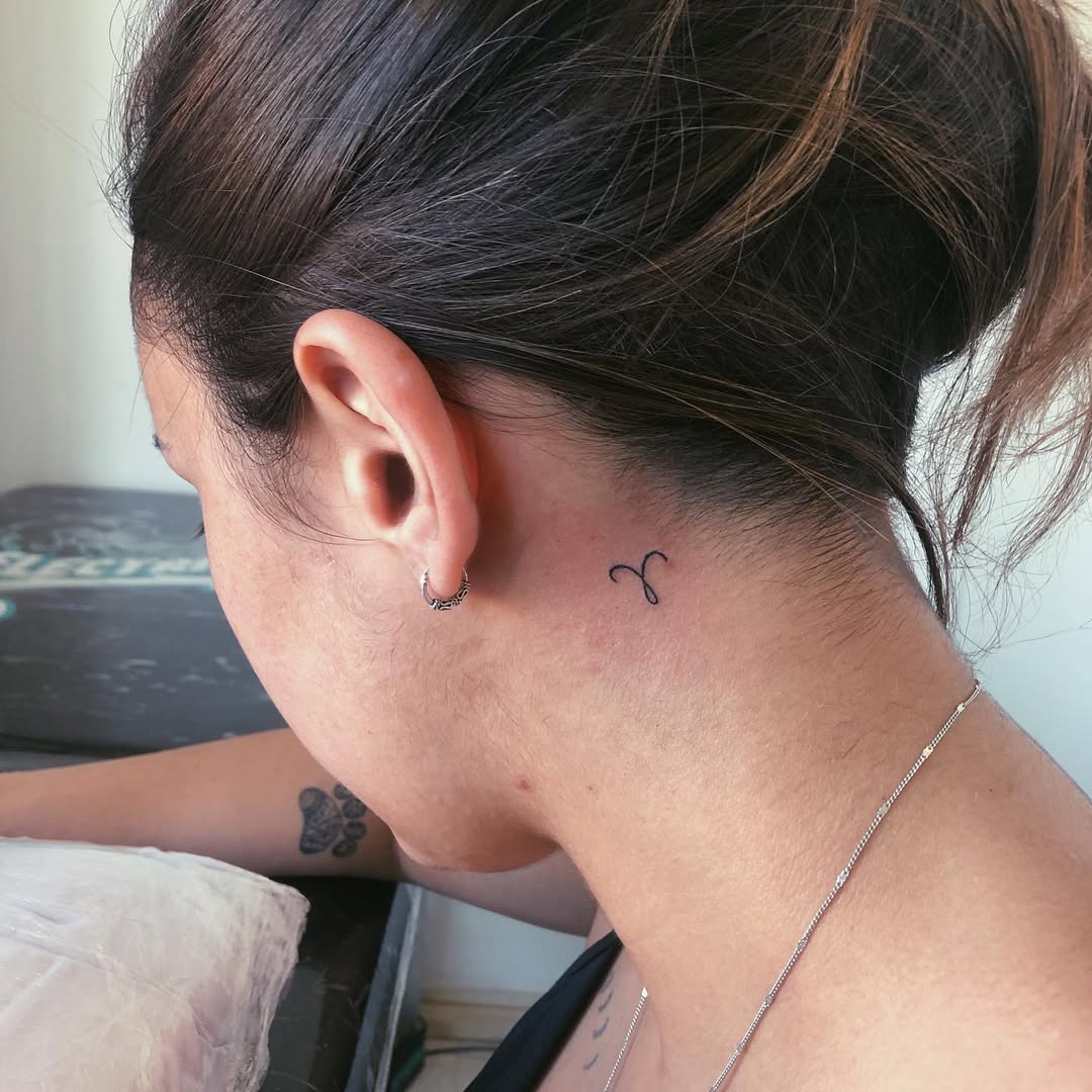 Minimalist Capricorn Tattoo on the Neck