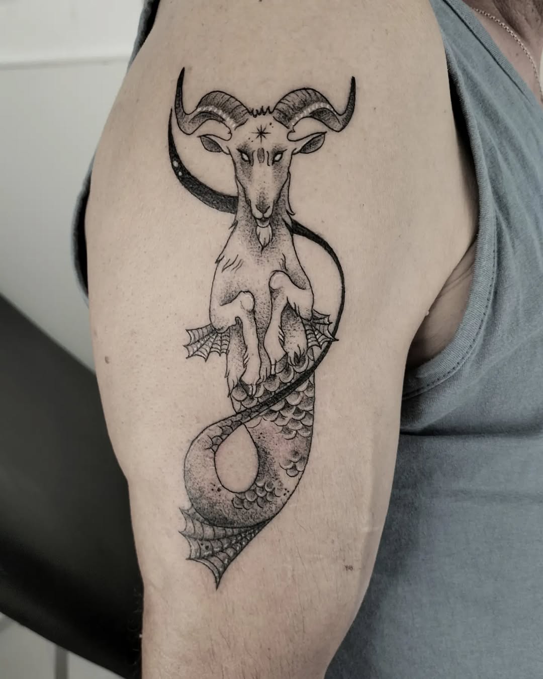 Bold Capricorn tattoo combining goat and serpent