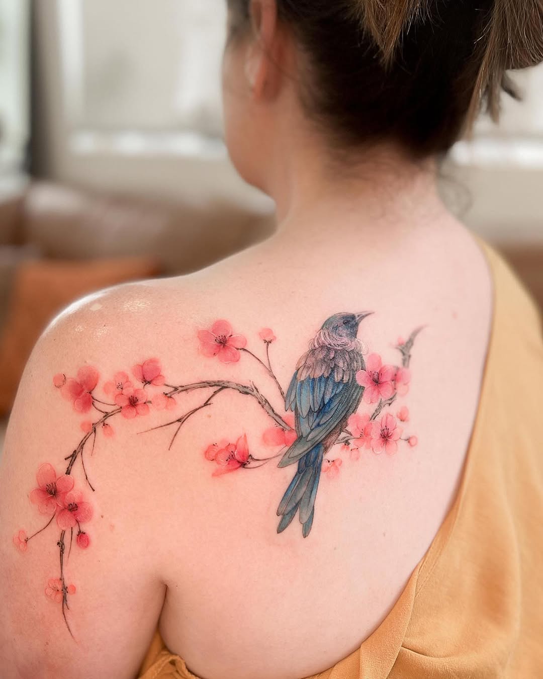 Stunning cherry blossom and bird tattoo fusion