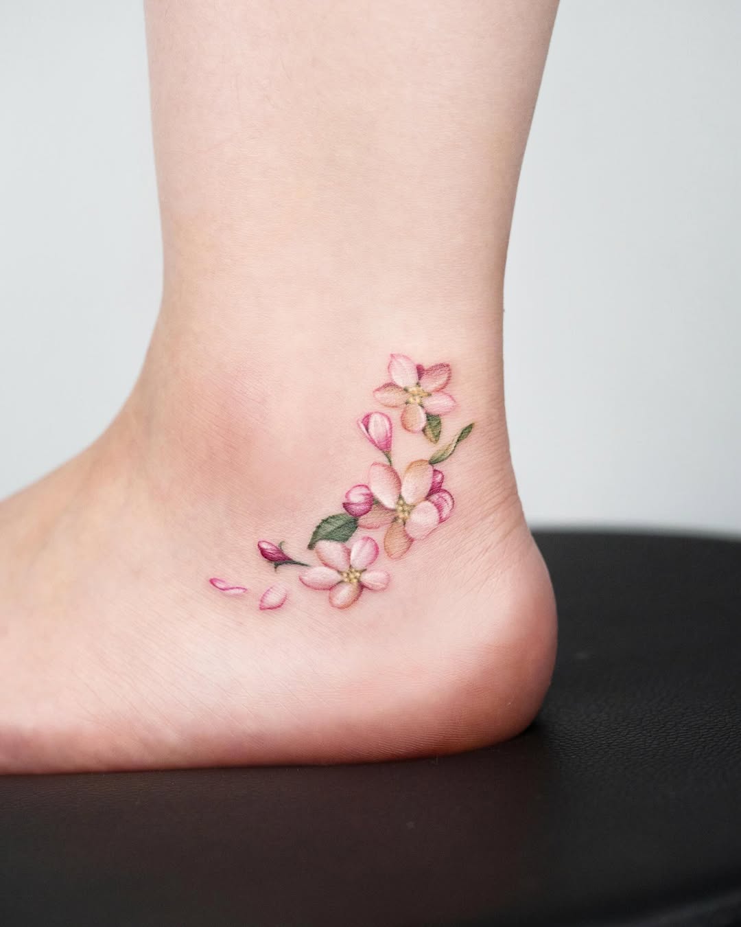 Delicate cherry blossoms adorn the ankle beautifully.