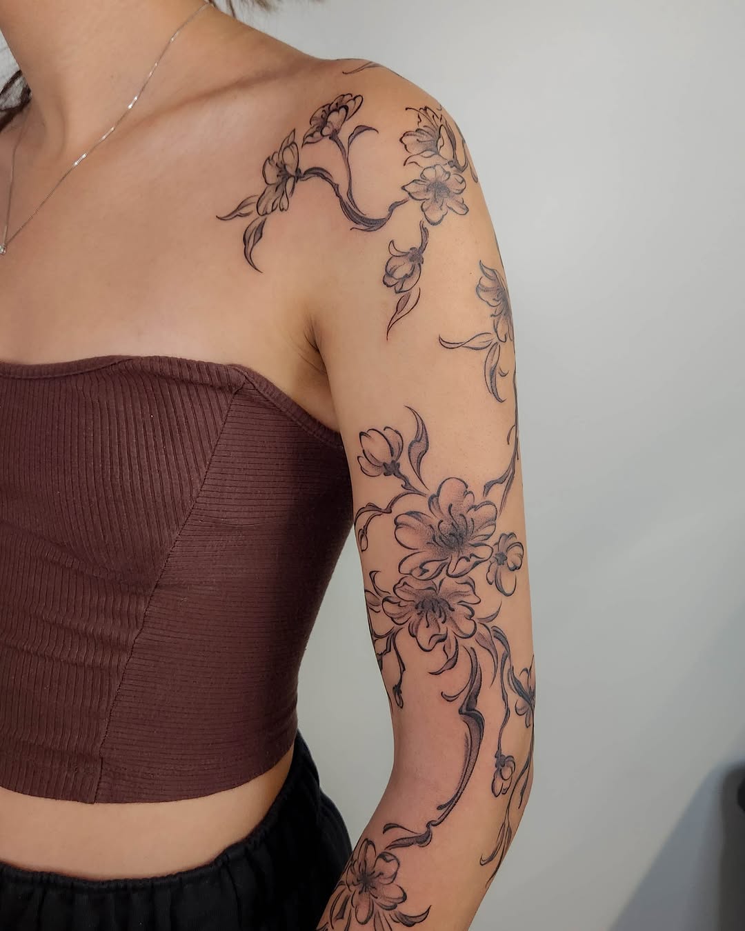 Elegant cherry blossoms wrapping beautifully around the arm