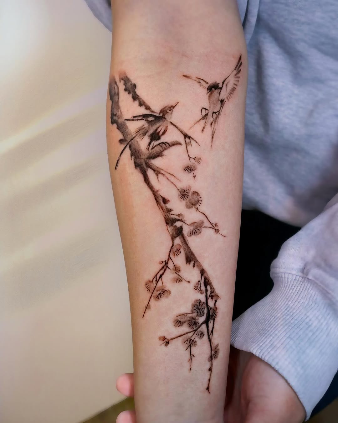 Elegant cherry blossom tattoo with bird design