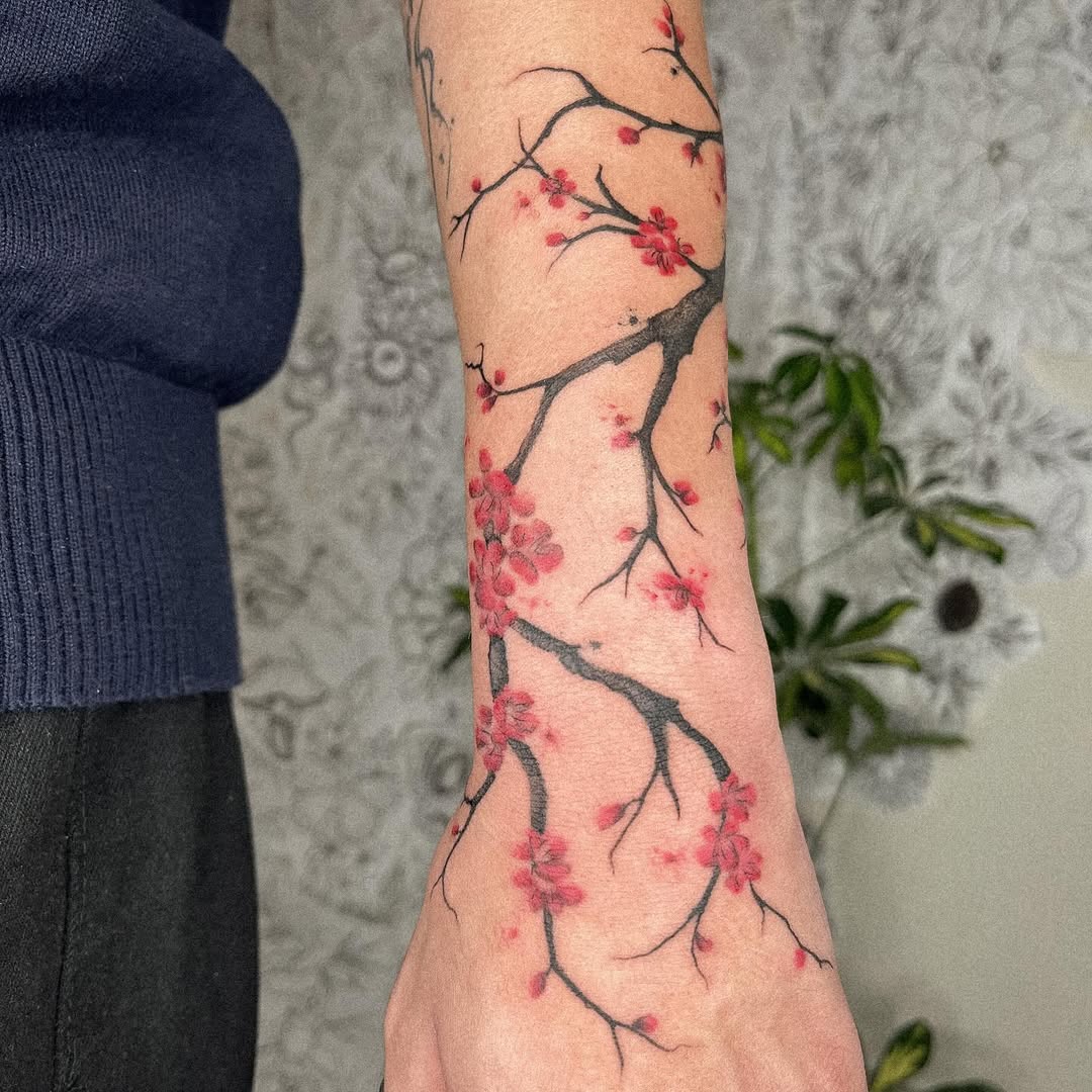 Elegant Cherry Blossom Tattoo on the Forearm