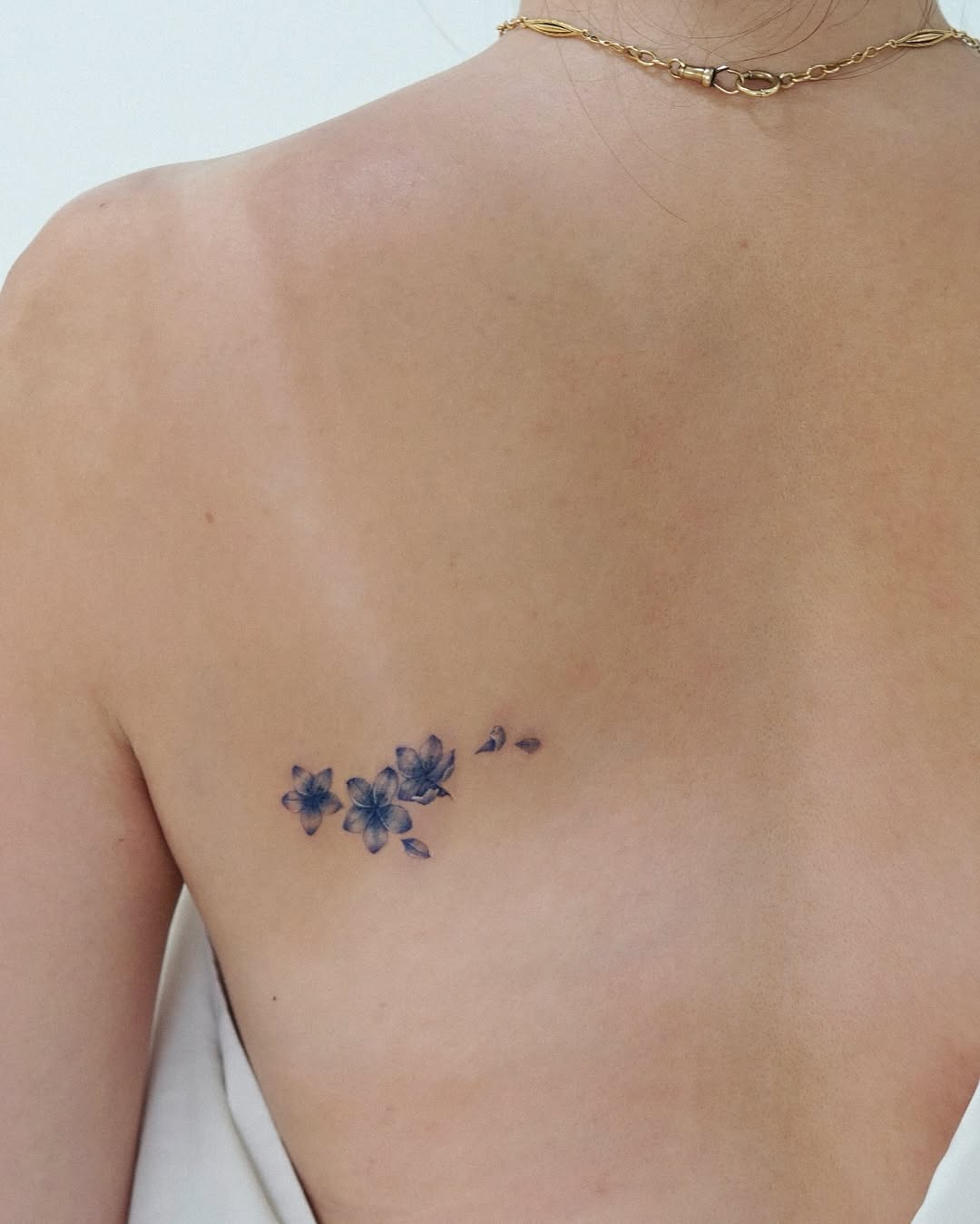 Delicate cherry blossoms inked on the back