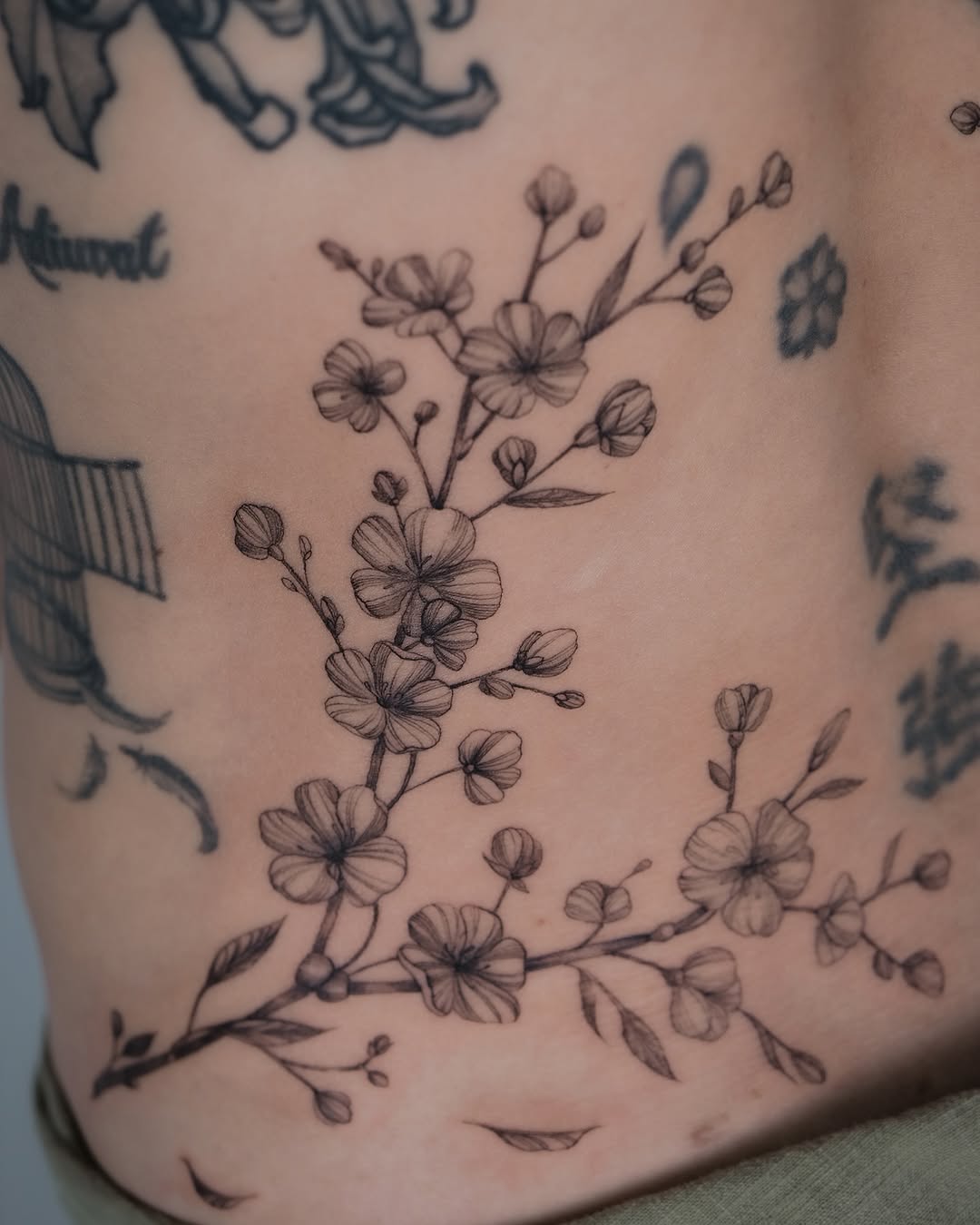 Elegant Cherry Blossom Tattoo Embracing Skin