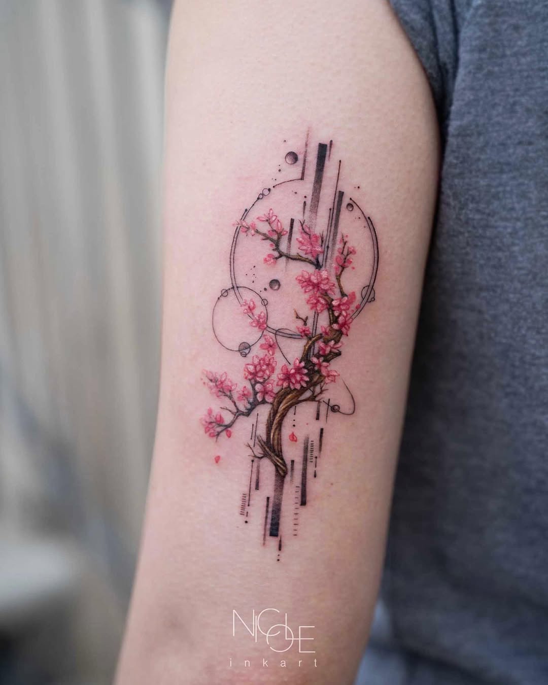 Elegant cherry blossom tattoo with modern elements