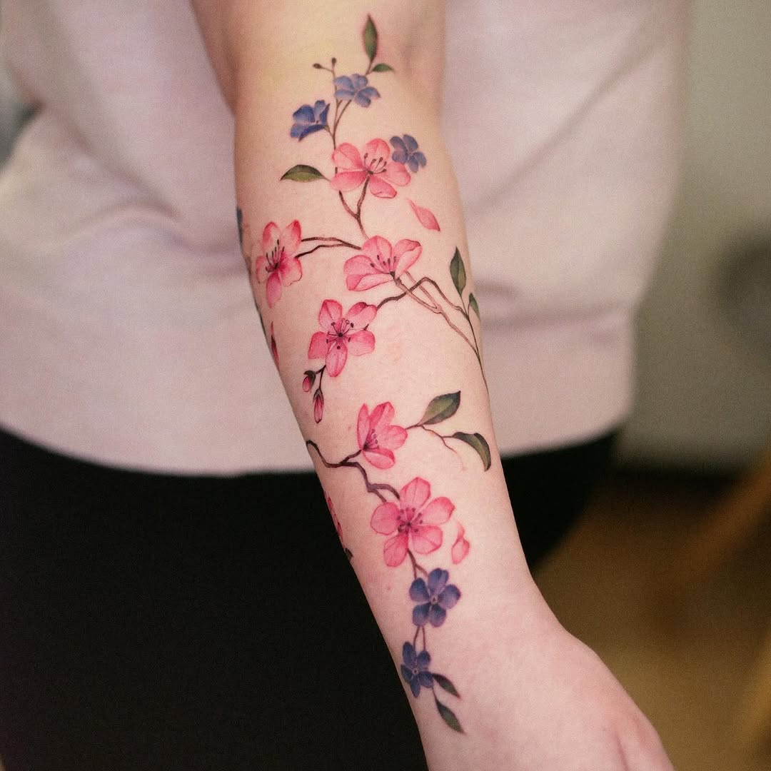 Elegant cherry blossom tattoo on forearm