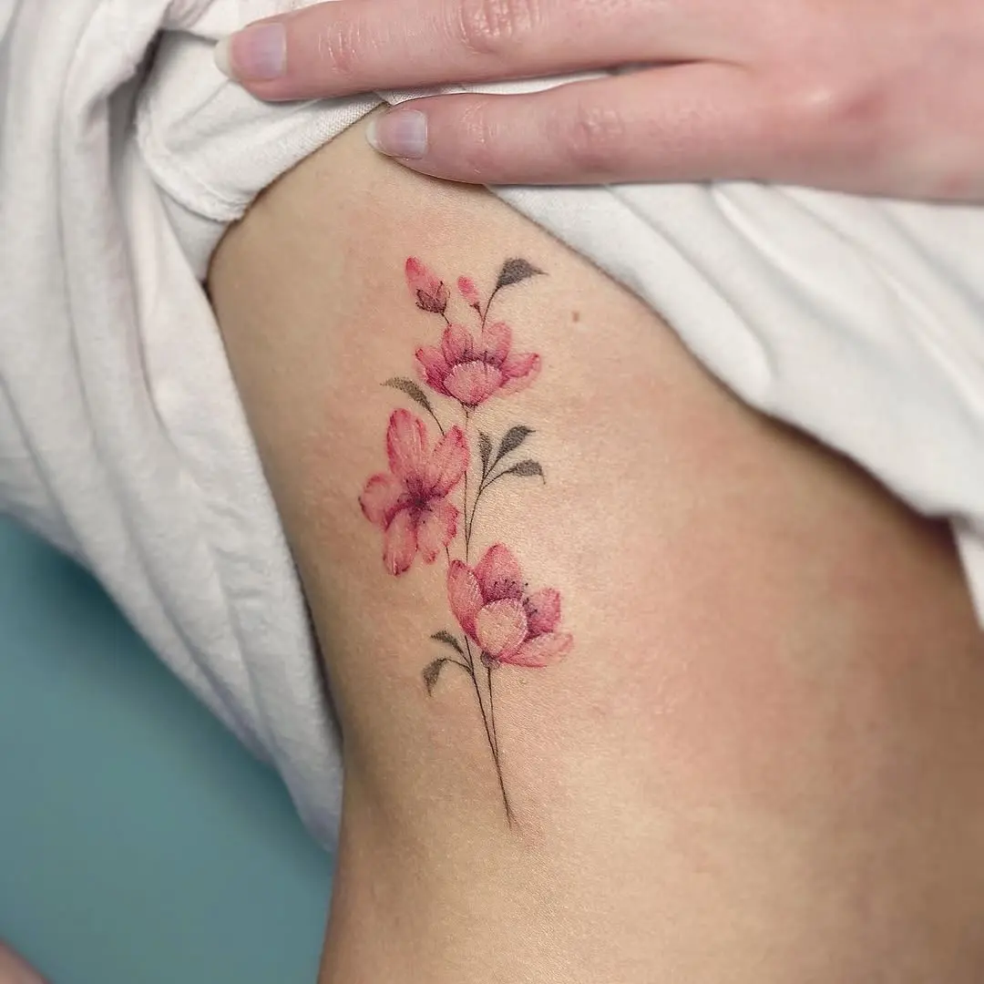 Elegant cherry blossom tattoo on soft skin