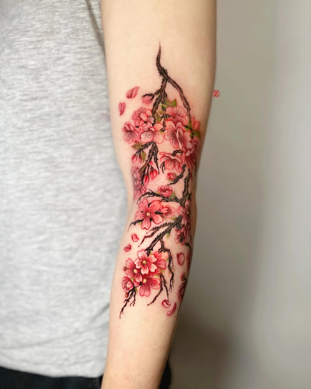 Elegant cherry blossom tattoo on arm