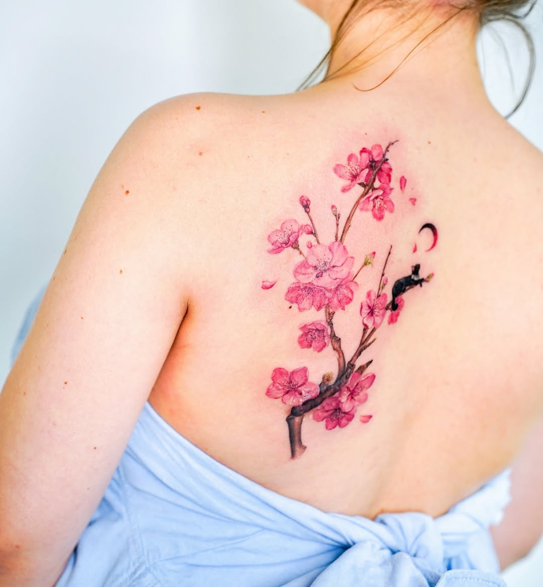 Elegant cherry blossom tattoo on the back