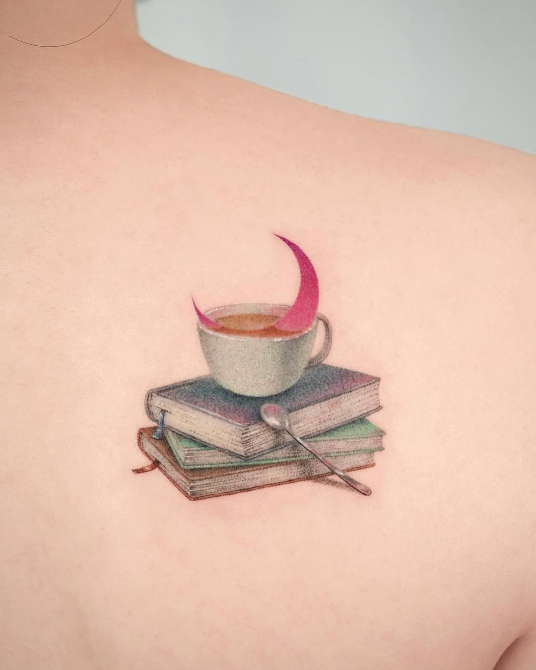 Whimsical coffee cup tattoo with books design