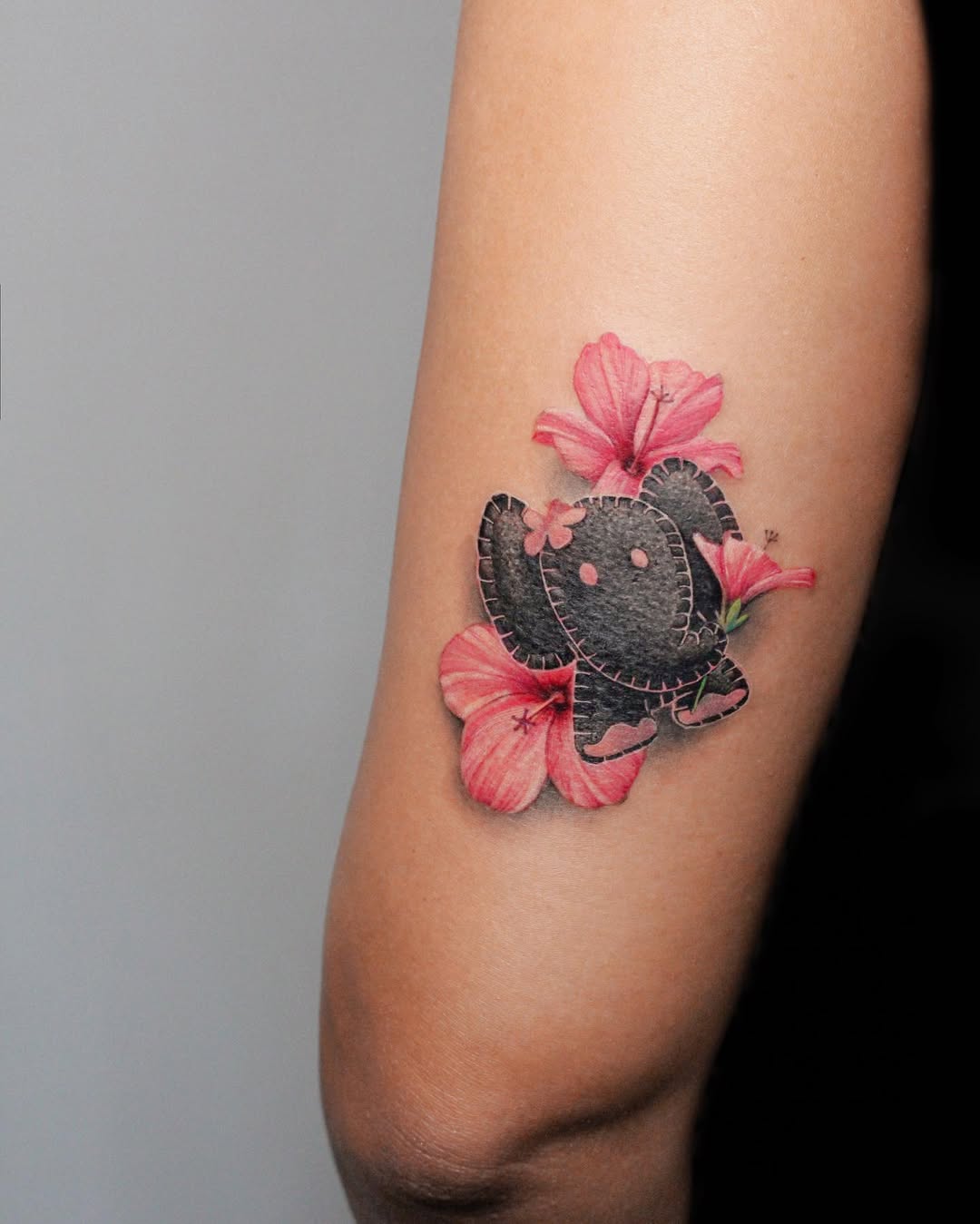 Whimsical elephant tattoo with floral accents