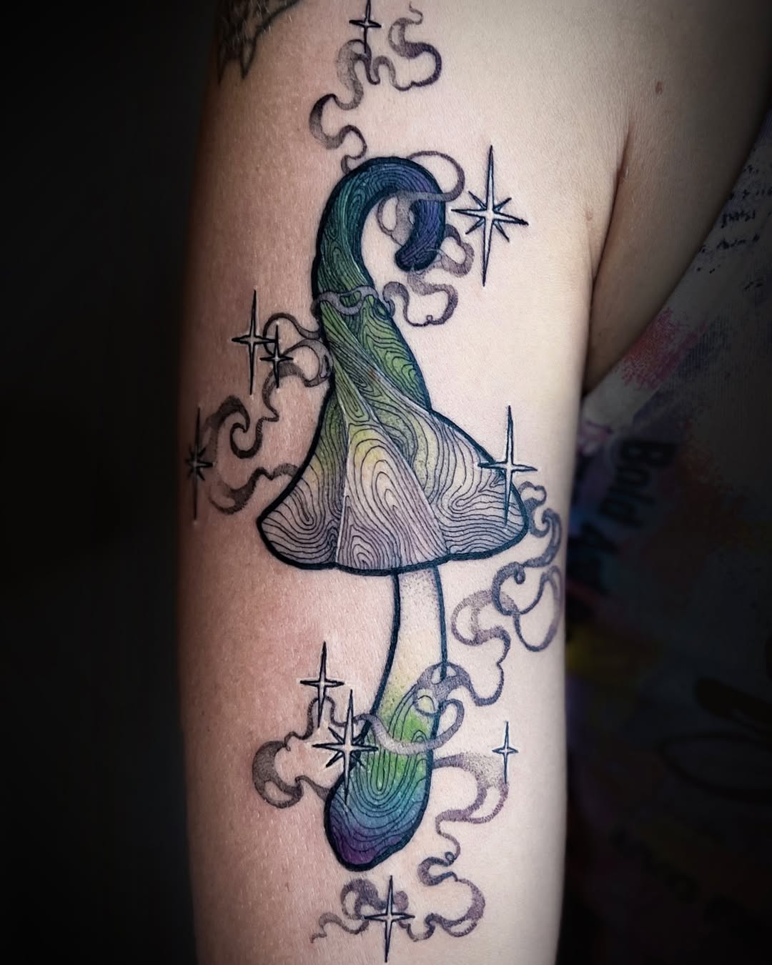 Whimsical mushroom tattoo with swirling colors