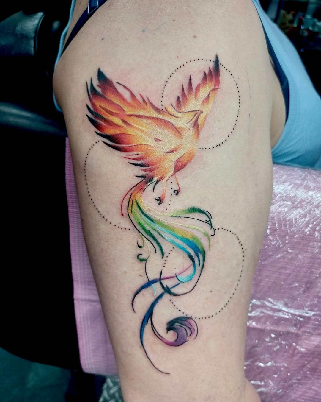 Vivid phoenix tattoo showcasing rainbow hues