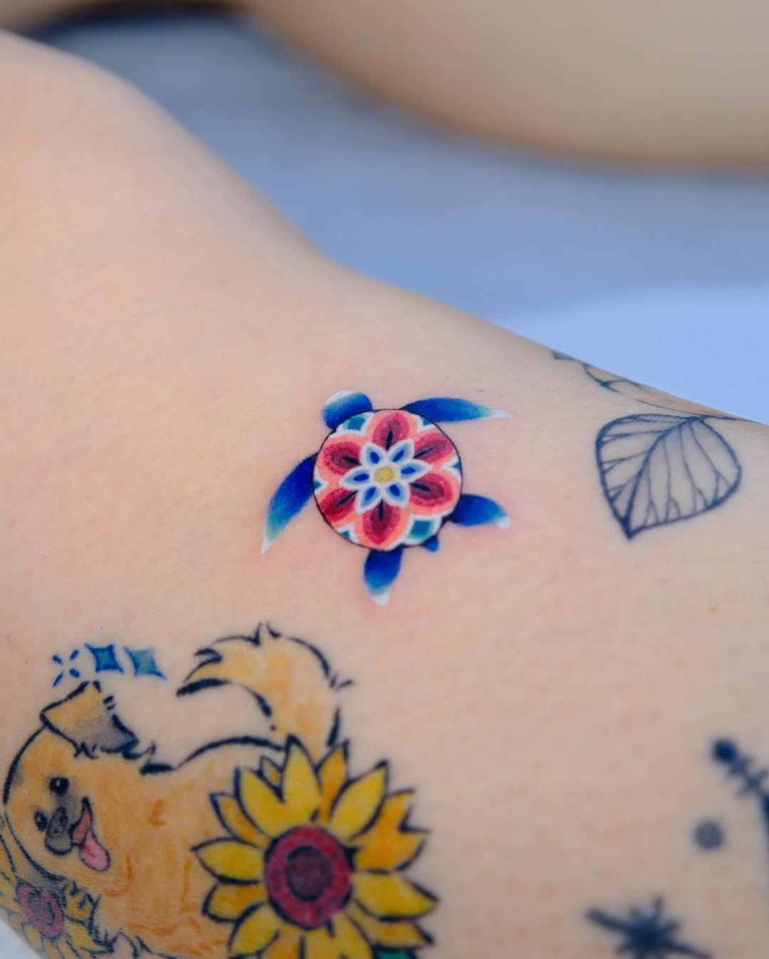 Vibrant sea turtle tattoo with floral design