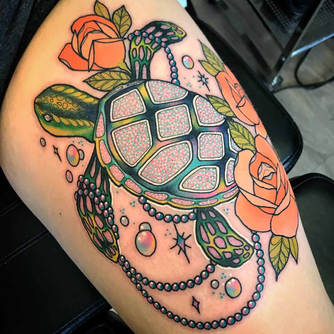 Colorful turtle tattoo with floral accents