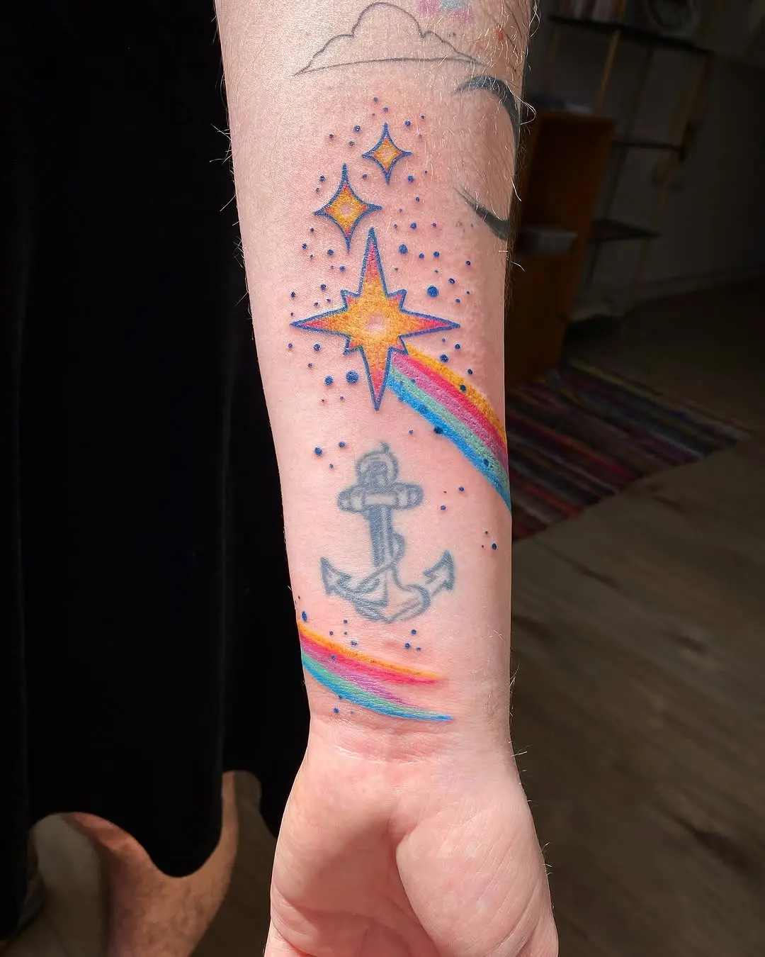 Vibrant Star Tattoo with Rainbow Accents