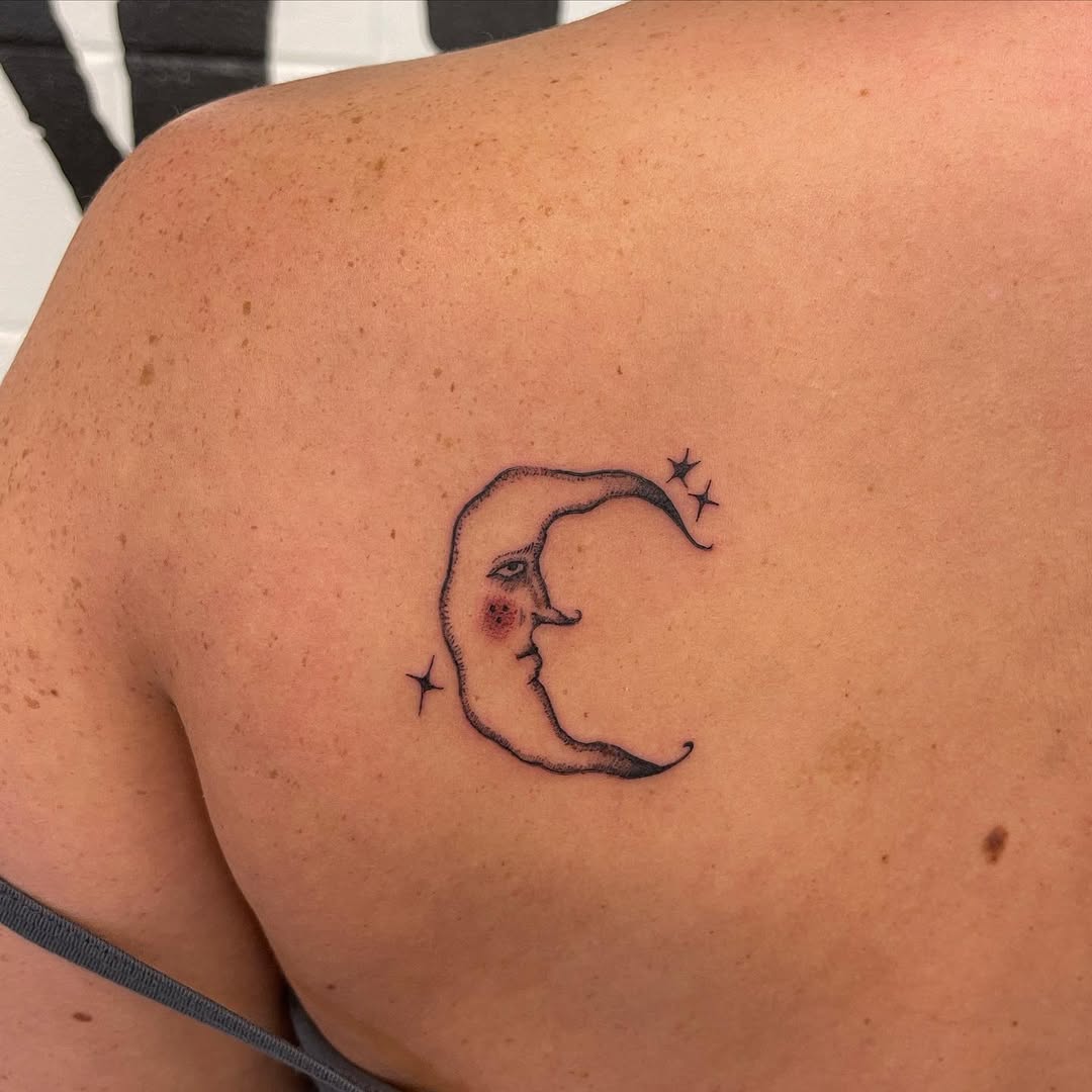 Charming crescent moon tattoo with face details