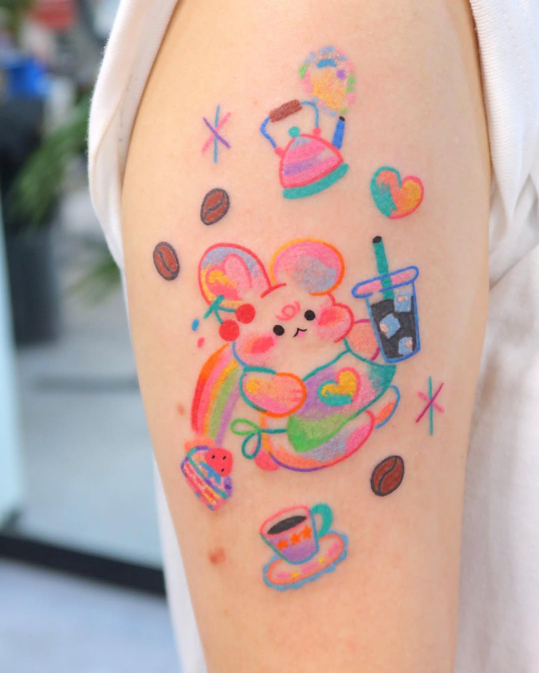 Whimsical mouse enjoying coffee artfully tattooed