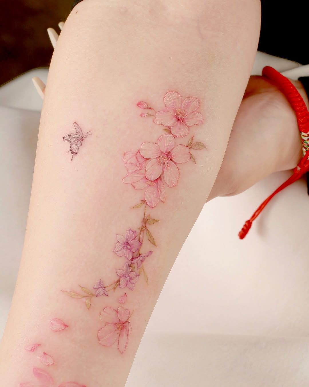 Elegant cherry blossom tattoo with soft details