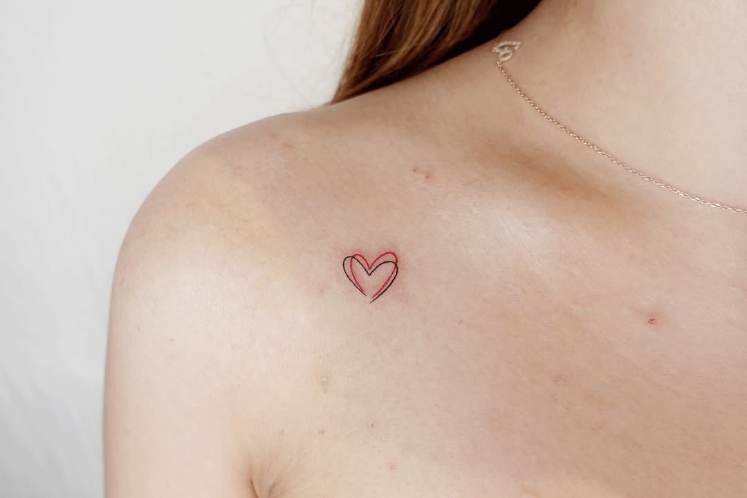 Charming minimalist heart tattoo on shoulder