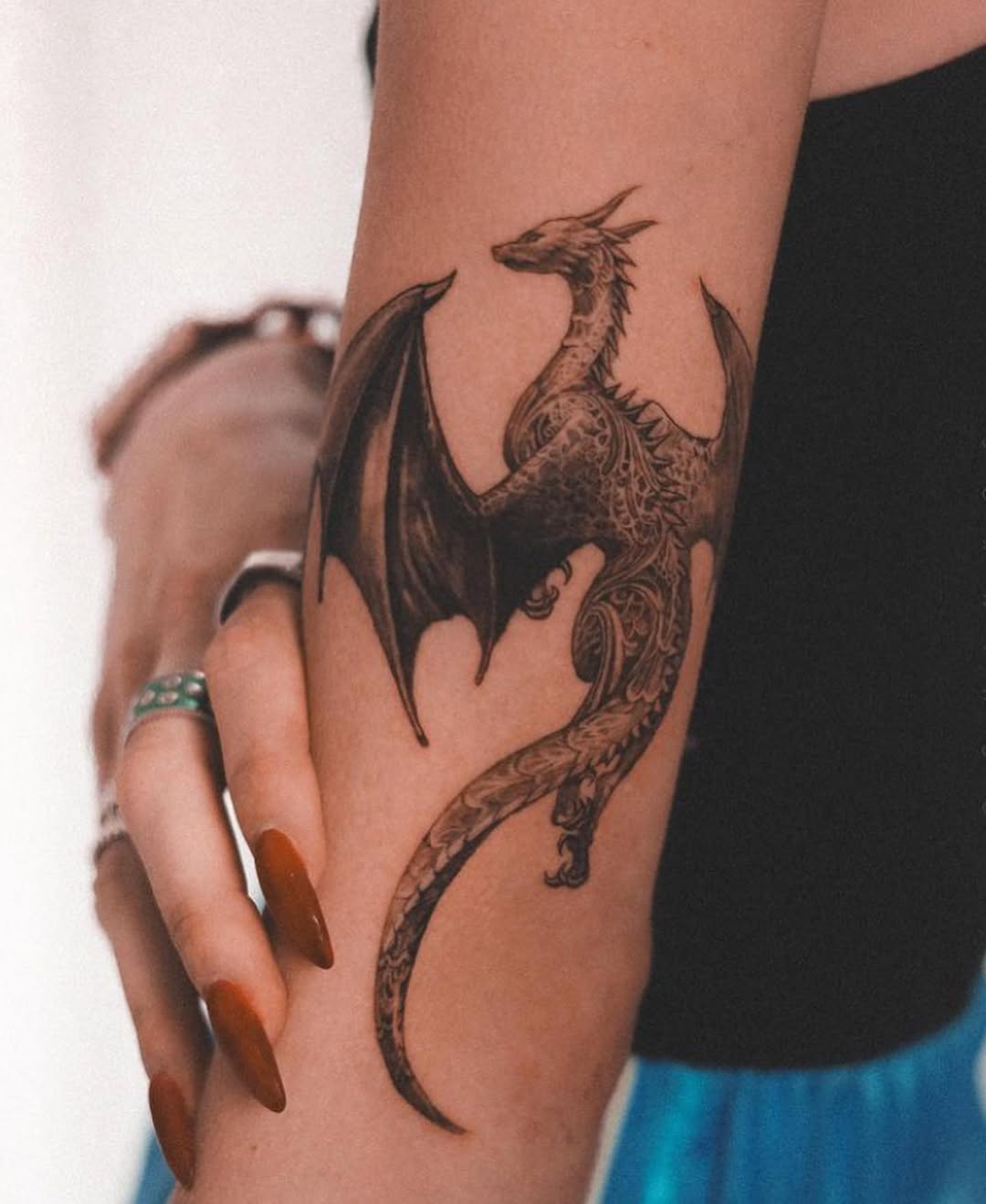 Intricate dragon tattoo on a woman's arm