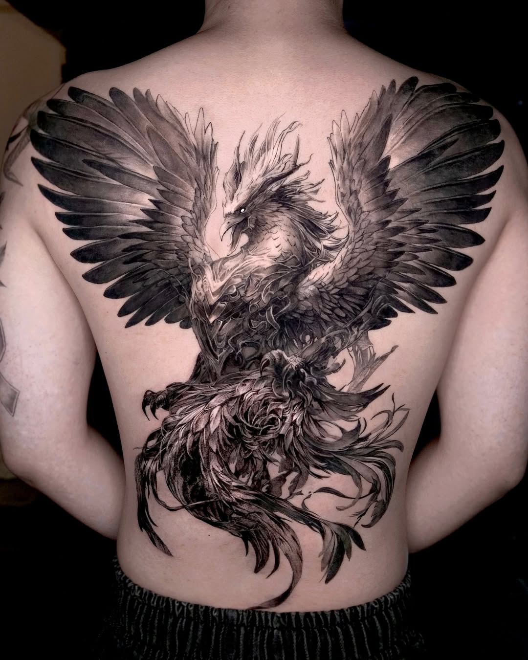 Majestic phoenix tattoo soaring across the back