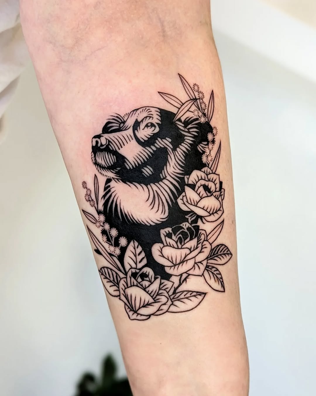 Stunning dog tattoo surrounded by roses