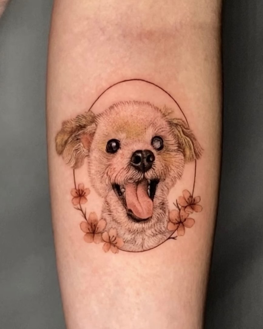 Adorable puppy tattoo with floral accents