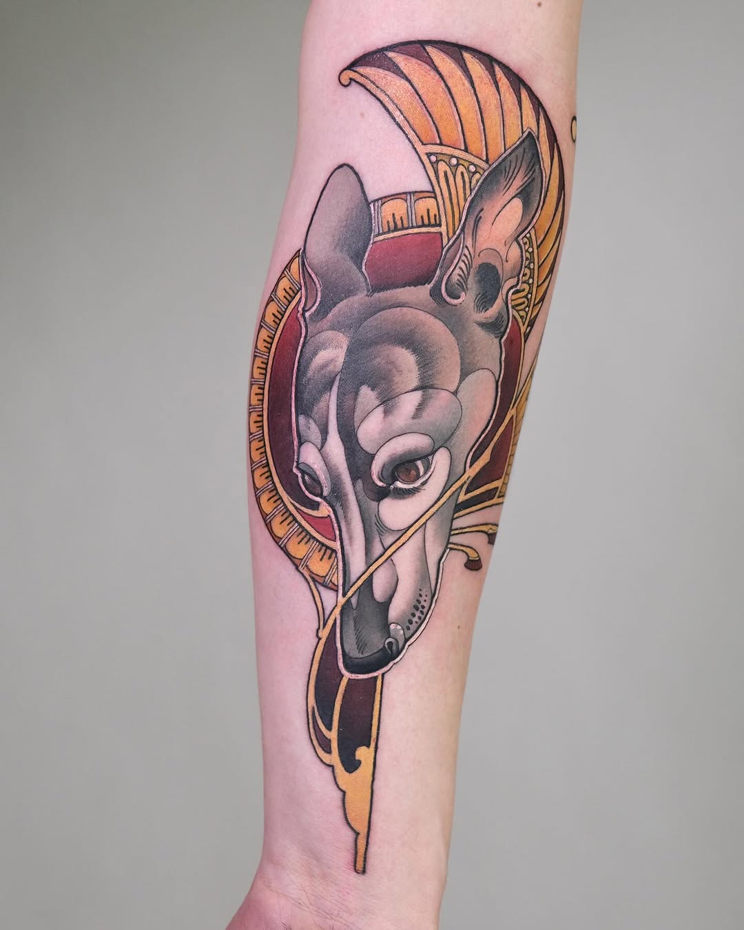 Stunning ornamental dog tattoo on forearm