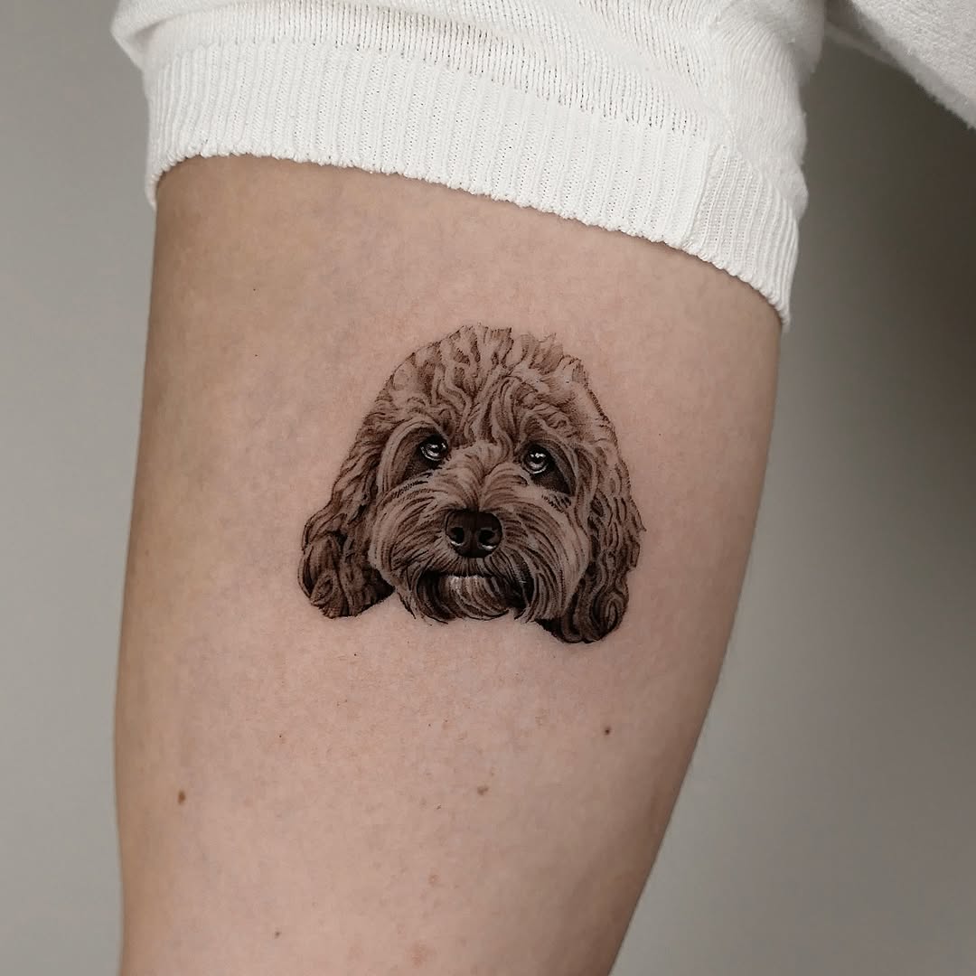 Adorable realistic dog tattoo on thigh