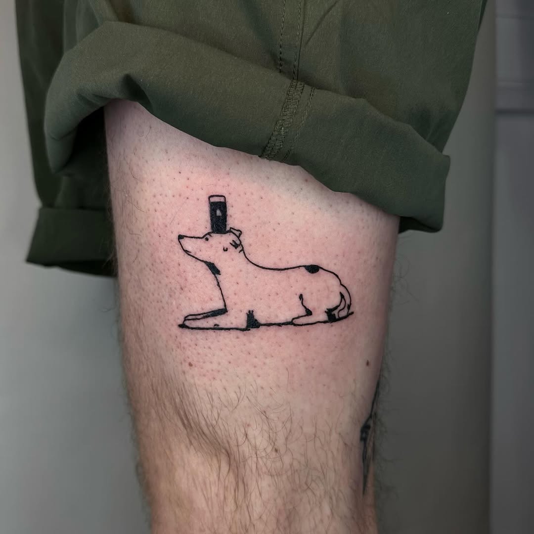 Minimalist dog tattoo on thigh area