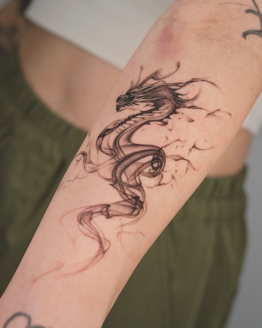 Expressive Fine Line Dragon Tattoo on Arm