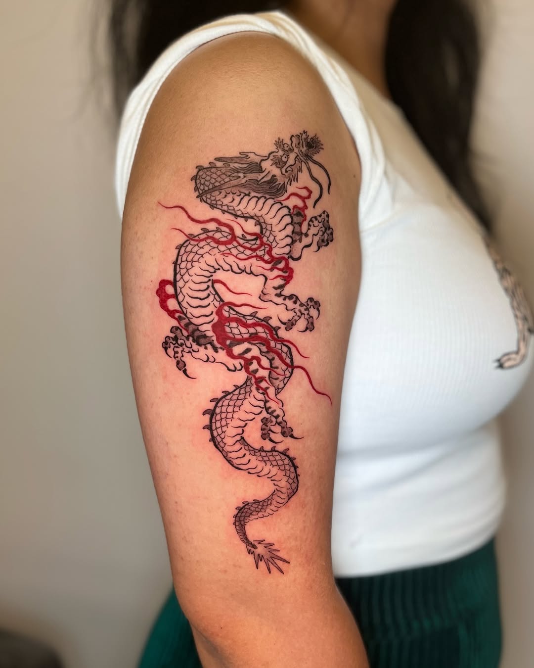 Bold Red Dragon Tattoo on Upper Arm