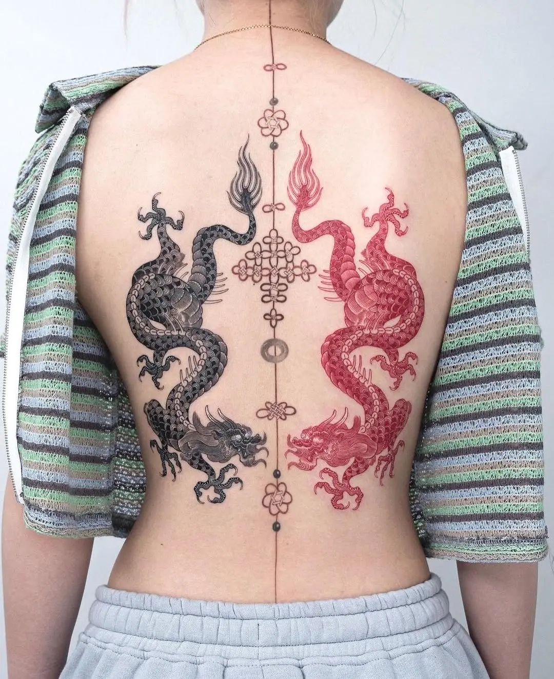 Stunning symmetrical dragon tattoo design on back