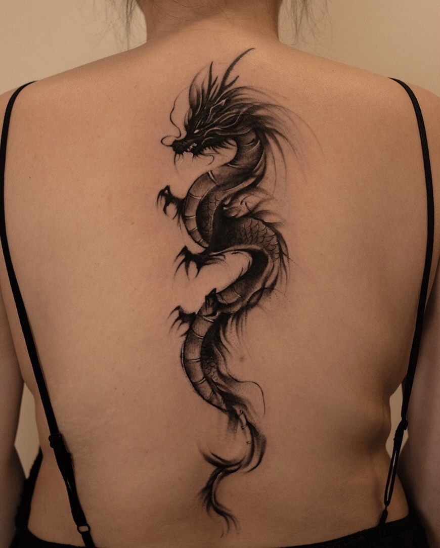 Elegant black ink dragon tattoo on the back