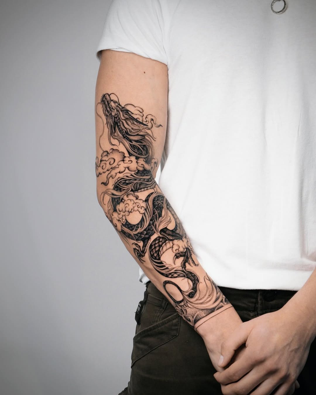 Intricate dragon tattoo with waves and clouds