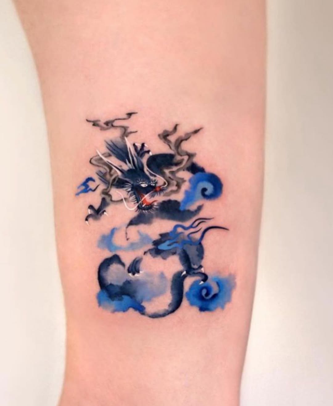 Stylish dragon tattoo emerging from swirling clouds