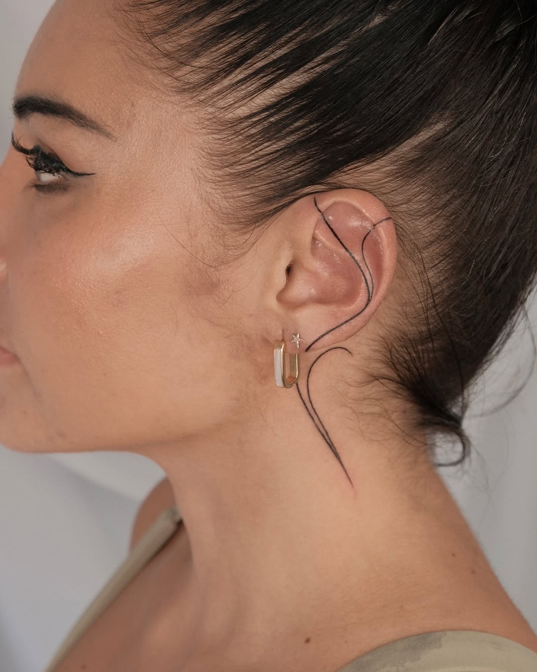 Sleek and stylish ear tattoo design