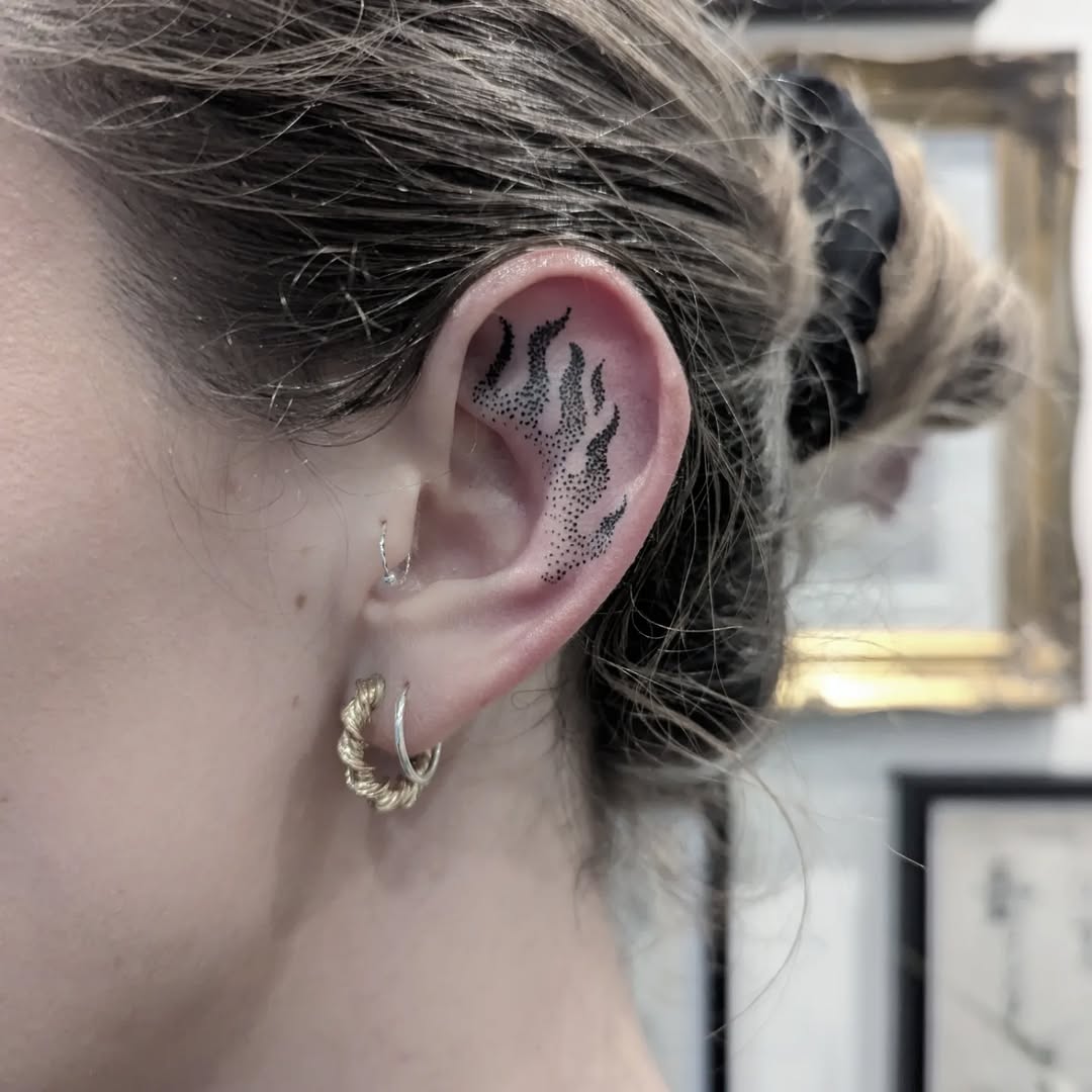 Stylish flame tattoo on the ear