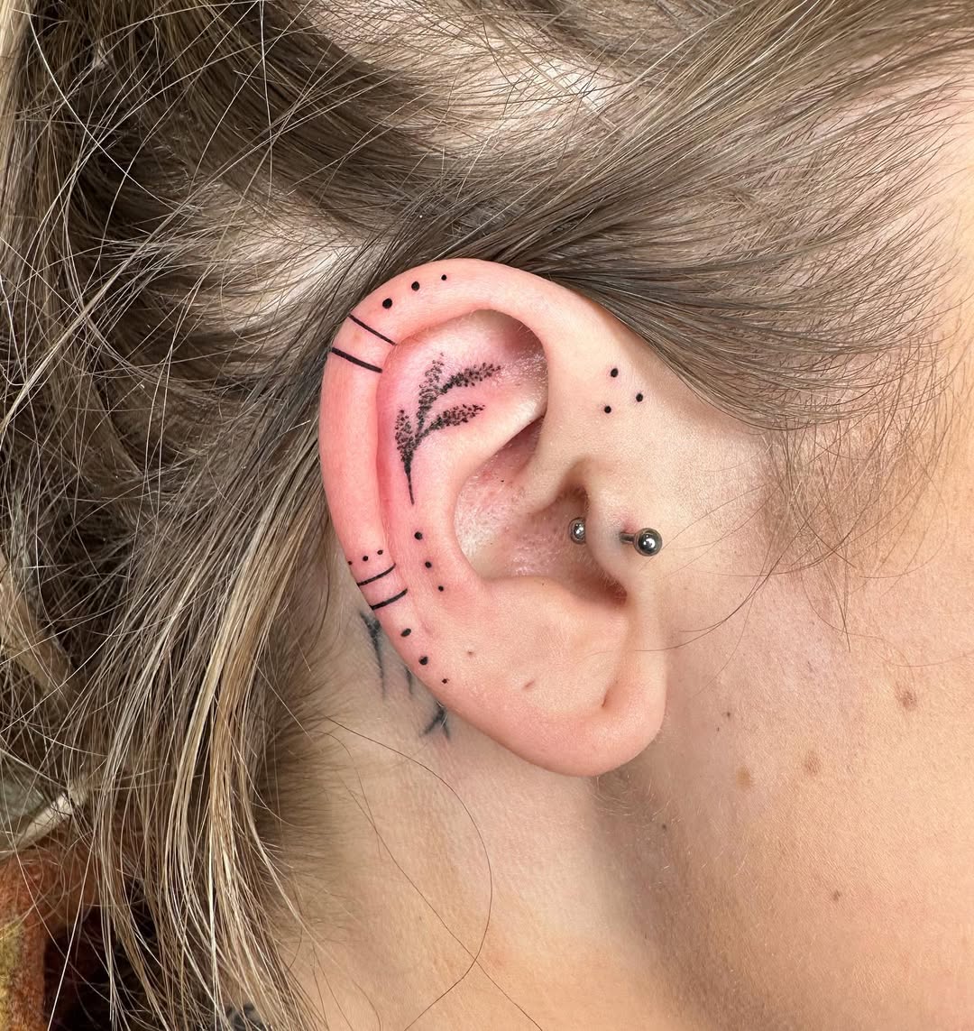 Stylish floral ear tattoo highlighting subtleness