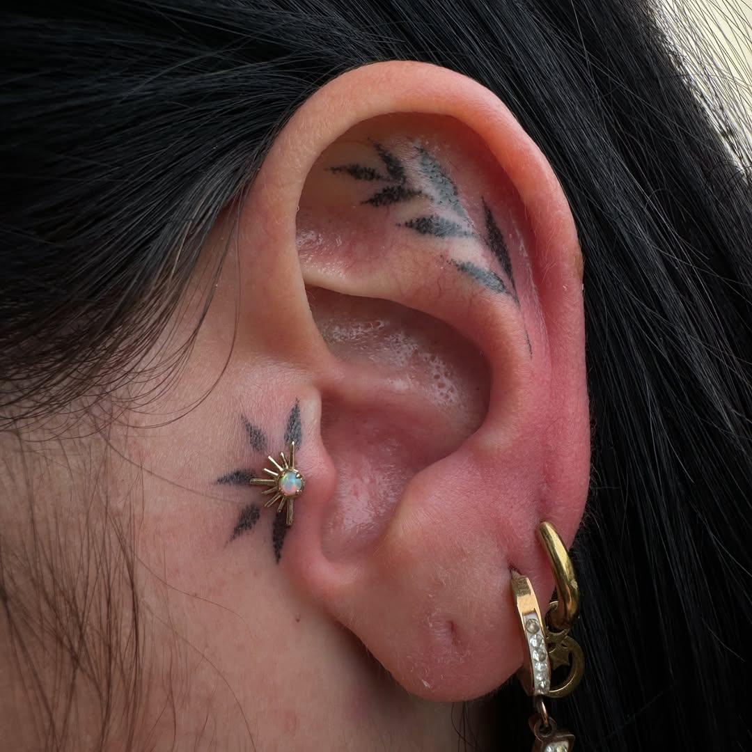 Chic ear tattoos with floral and leaf designs