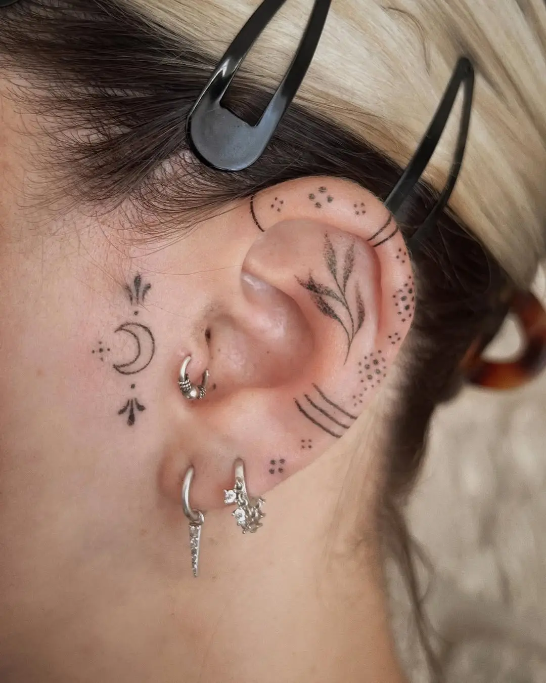 Intricate ear tattoos for a unique vibe