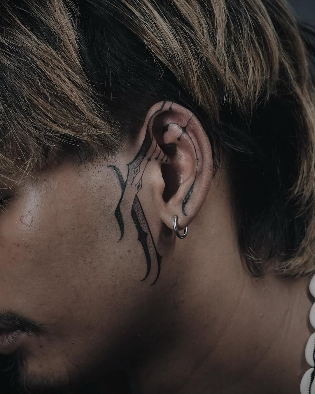 Bold Lines and Unique Ear Tattoo Styles