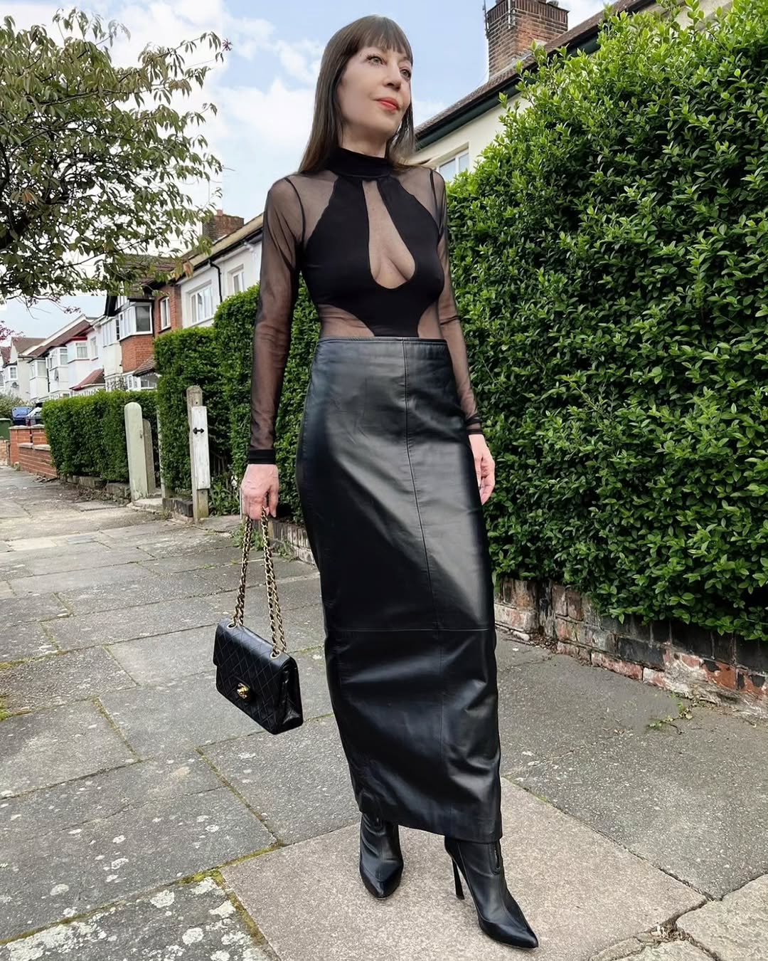 Chic black leather skirt with daring top