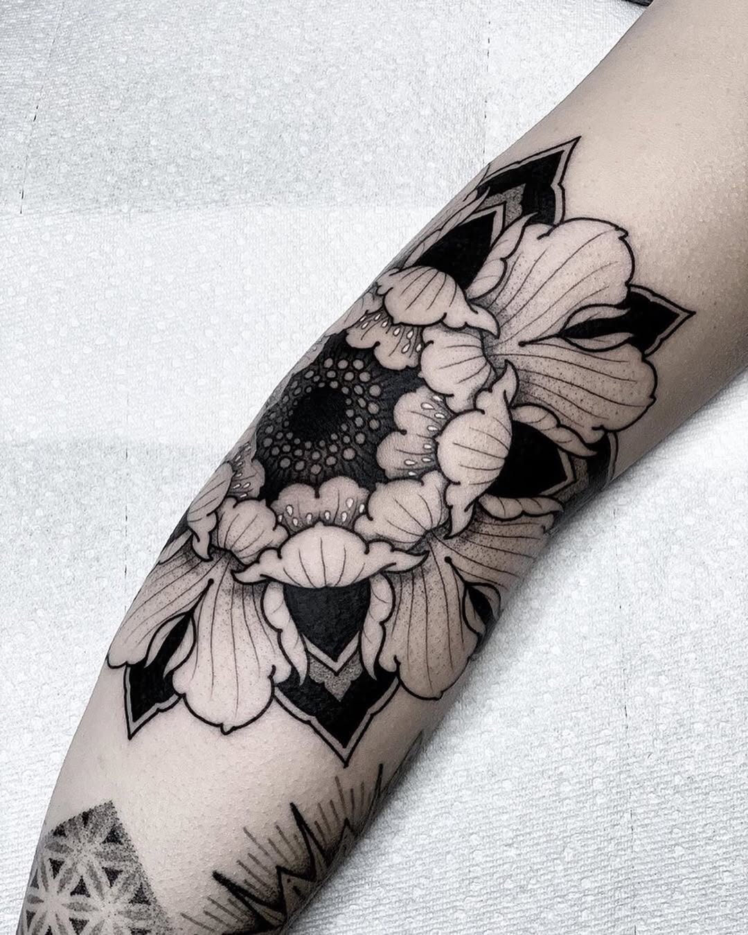 Stunning floral elbow tattoo design in blackwork